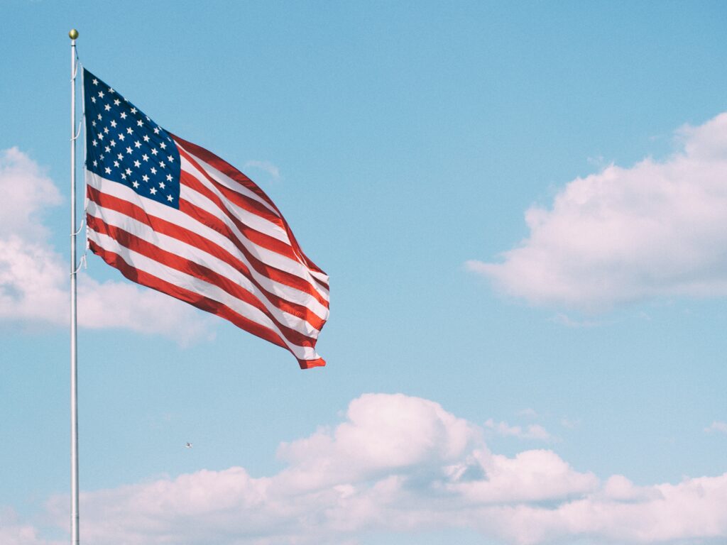 US flag waving in the blue sky