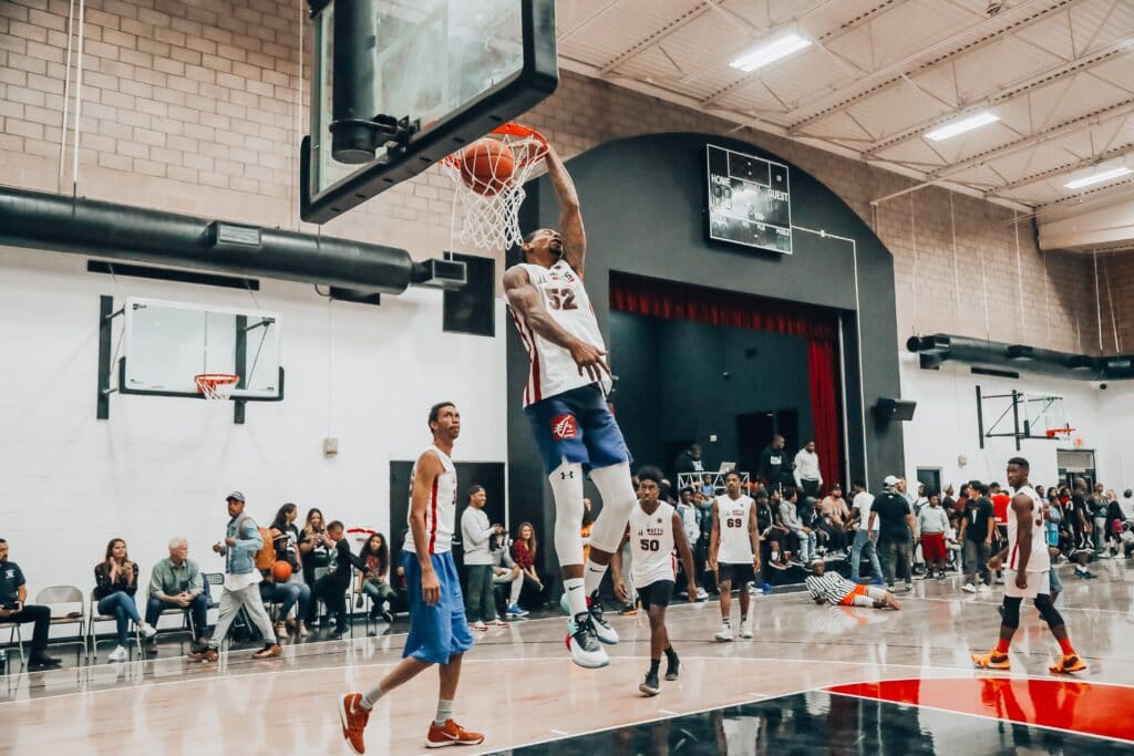 Basketball player performing a slam dunk