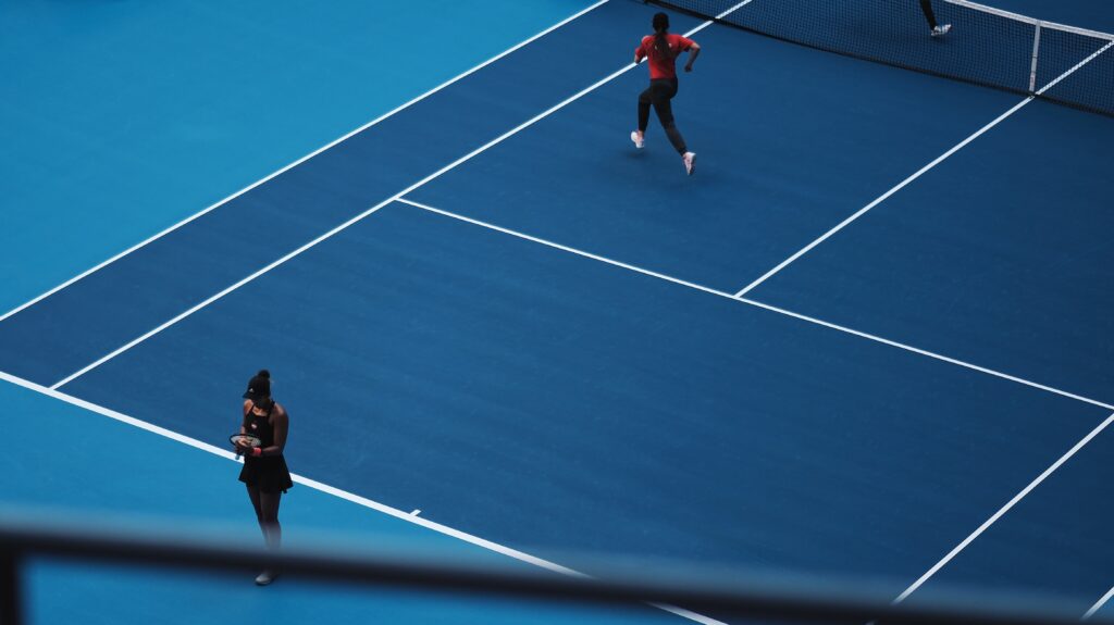 Female tennis player on blue tennis court